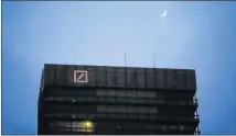  ??  ?? DARK DAYS: The moon rises over an office building of Germany's largest bank, Deutsche Bank AG in Frankfurt PHOTOGRAPH: REUTERS