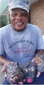  ?? Staff photo by Neil Abeles ?? ■ Lindenite Lou Wilson makes artistic faces from the iron ore pieces he finds in the shallow waters of Iron Ore Lake in Linden.