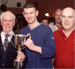  ??  ?? Left, Former bar manager, Gerry Coleman and hi s son Gavin, pictured with now President Michael D. Higgins during the 1987 President’s Cup Final. Above, Travel Club Away Player of the Year David Ward receives his trophy from Tom McNulty and Michael Conachy at the Dundalk Supporters Club Player of the Year Awards held in the Lilywhite Lounge.