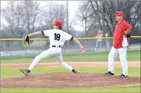  ?? Annette Beard/Pea Ridge TIMES ?? Head coach Matt Easterling watched as senior A.J. Boyd, No. 18, warms up to pitch in the game against the Alma Airdales Friday, March 6. Boyd pitched the final five innings and had three hits, one run (one earned) and one strikeout. The Blackhawks defeated the Airdales 7/6.