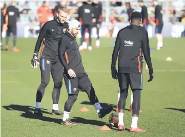  ??  ?? Barcelona’s Lionel Messi (centre) with teammates during training. — AFP photo