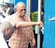  ??  ?? Dr Peter Philips, leader of the Opposition, painting a portion of the entrance to the Ward Theatre on Labour Day.