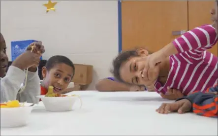  ?? PHOTO PROVIDED ?? Local kids in Boys &amp; Girls Clubs of the Capital Area programs enjoy a meal.