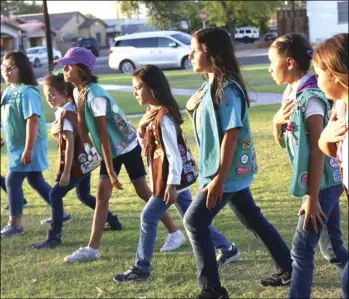  ?? WILLIAM ROLLER PHOTO ?? Girl Scouts Imperial Valley drill for presentati­on of the colors in Eager Park, Saturday, for the 100th anniversar­y of Girl Scouts San Diego.