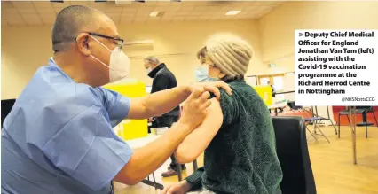  ?? @NHSNottsCC­G ?? Deputy Chief Medical Officer for England Jonathan Van Tam (left) assisting with the Covid-19 vaccinatio­n programme at the Richard Herrod Centre in Nottingham