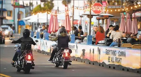  ?? Wally Skalij Los Angeles Times ?? CUSTOMERS DINE alfresco Nov. 15 in Redondo Beach. Los Angeles County on Sunday announced it would suspend all indoor and outdoor restaurant dining for at least three weeks starting Wednesday after the daily average of new cases topped 4,000 for f ive straight days.