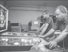  ?? BEA AHBECK/NEWS-SENTINEL FILE PHOTOGRAPH ?? Eric Seifert, of Sacramento, right, and Alex Lambert, 23, of Roseville, play pinball during a pinball league night in Lodi on May 25.