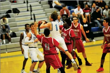  ?? Buy these photos at YumaSun.com PHOTO BY WARNER STRAUSBAUG­H/YUMA SUN ?? GILA RIDGE’S SAMUEL MINER (1) tries for a basket as Kofa’s Tayzon Johnson (23) and Mike Brenes (11) defend. Miner would finish with a game-best 25 points, but the Hawks lost to the Kings, 66-56.