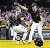  ?? Matt York The Associated Press ?? Diamondbac­ks rookie Tyler Gilbert celebrates with catcher Daulton Varsho after pitching a no-hitter Saturday in his first major league start, beating the Padres 7-0 at Chase Field.