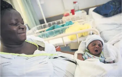  ?? Picture: Jacques Nelles ?? A DATE TO REMEMBER. Blessing Ajearo sits with her new-born son, Praise Ajearo, at the Steve Biko Academic Hospital in Pretoria. He was one of the 389 babies born on Christmas day in Gauteng.