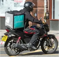  ??  ?? Meals on wheels: A moped driver with L-plates