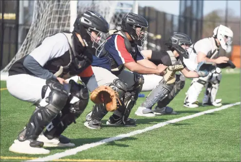  ?? Dave Stewart / Hearst Connecticu­t Media ?? Norwalk catchers, from left, Jack Roberts, William Wilds, Will Arnold and Jaden Echevarria during the first week of pitchers and catchers at the Nathan Hale Middle School in March.