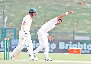  ?? — AFP photo ?? Pakistan cricketer Mohammad Abbas (R) bowls during day four of the second Test match between Australia and Pakistan at Sheikh Zayed stadium in Abu Dhabi on October 19, 2018.