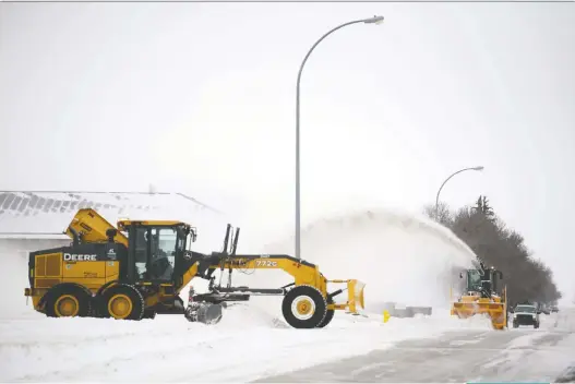  ?? TROY FLEECE ?? Crews clear snow from city streets on Friday. A snow removal official says the city has seen more precipitat­ion than at this time last year.