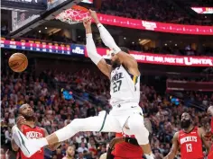  ?? AP Photo/Kim Raff, File ?? ■ Utah Jazz’s Rudy Gobert (27) dunks during the second half of an NBA game against the Houston Rockets on Feb. 22 in Salt Lake City. Gobert is standing tall, even after having coronaviru­s and dealing with an enormous amount of scorn after being diagnosed.