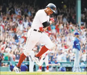  ?? Winslow Townson / Associated Press ?? Boston’s Xander Bogaerts celebrates while rounding the bases after hitting a grand slam in the 10th inning of Saturday’s 6-2 victory over the Blue Jays.