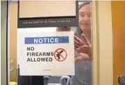  ?? JAY JENNER/AUSTIN AMERICAN-STATESMAN VIA ASSOCIATED PRESS ?? University of Texas at Austin anthropolo­gy professor Pauline Strong posts a sign prohibitin­g guns at her office on the first day of the new campus-carry law Monday.