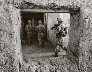  ?? File photo ?? U.S. soldiers search a house near Mushara, Iraq, in 2007. During the 2003 invasion of Iraq, the guidance for disclosing informatio­n urged that decisions be made “preferably in minutes, not hours.” The military has retreated from that position.