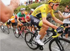  ??  ?? Britain’s Chris Froome, right, and new overall leader Fabio Aru of Italy, center, climb Peyresourd­e pass, during the 12th stage of the Tour de France cycling race, Thursday. (AP)