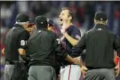  ?? MATT SLOCUM — THE ASSOCIATED PRESS ?? Washington Nationals pitcher Max Scherzer reacts as he talks with umpires during a foreign substances check in the middle of the fourth inning of a game against the Philadelph­ia Phillies, Tuesday, in Philadelph­ia.