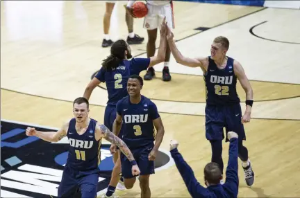  ?? ROBERT FRANKLIN - THE ASSOCIATED PRESS ?? Oral Roberts players celebrate after beating Ohio State in a first-round game in the NCAA men’s college basketball tournament, Friday, March 19, 2021, at Mackey Arena in West Lafayette, Ind.