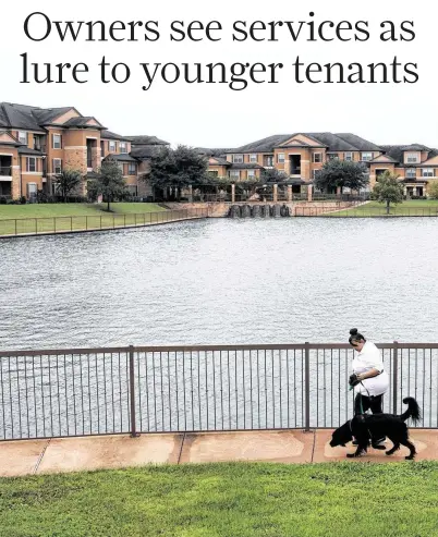  ?? Yi-Chin Lee / Staff photograph­er ?? Valet Living Home associate Angela Dubose walks Bohdi at Falls at Copper Lake Apartments. The company best known for doorside trash pickup also provides on-call pet visits, dry cleaning, housekeepi­ng and fitness.