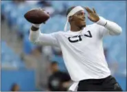  ?? BOB LEVERONE — THE ASSOCIATED PRESS ?? Carolina Panthers’ Cam Newton throws a pass during warm ups before the start of an NFL preseason football game against the New England Patriots in Charlotte, N.C., Friday. New England won 19-17.