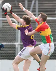  ??  ?? Niall Hughes claims a mark ahead of Carlow’s Gary Kelly.