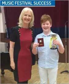  ??  ?? Adjudicato­r Niamh Murray with Jake Molloy, winner of the St Anthony’s Cup for junior boy’s solo for the second year in a row, at the Kilcoole Music Festival on Sunday.