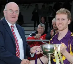  ??  ?? Páraic O’Keeffe receives the trophy from John Horan (Chairman).