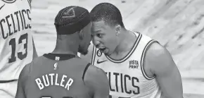  ?? BOB DECHIARA/USA TODAY SPORTS ?? Heat forward Jimmy Butler, left, and Celtics forward Grant Williams butt heads during Game 2 of the Eastern Conference final.