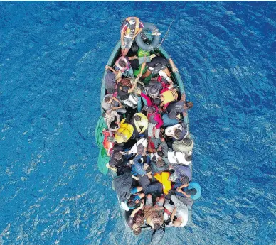  ?? MARCOS MORENO / AFP / GETTY IMAGES ?? A boat carrying migrants is stranded in the Strait of Gibraltar before being rescued by Spanish crews on Sept. 8. Spain has overtaken Italy as the preferred destinatio­n for people desperate to reach Europe.