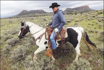  ?? SALT LAkE TRIBuNE vIA AP ?? In this May 9 photo, Interior Secretary Ryan Zinke rides a horse in the new Bears Ears National Monument near Blanding, Utah. Zinke said he’s recommendi­ng that none of 27 national monuments carved from wilderness and ocean and under review by the Trump...