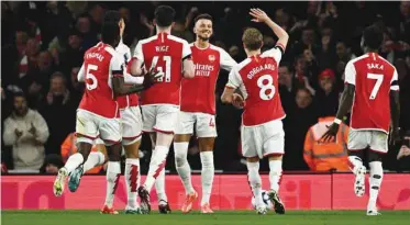  ?? (Reuters) ?? Arsenal’s Ben White (third right) celebrates with teammates after scoring against Chelsea during the Premier League match.