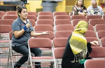  ?? Don Bartletti Los Angeles Times ?? IN A NEARLY EMPTY auditorium at White Middle School in Carson, Leslie Menjivar gives her opinion on L.A. Unified’s next superinten­dent. The input will be summarized in a report to the board next week.