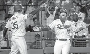  ?? John McCoy Getty Images ?? JUSTIN TURNER is congratula­ted by Cody Bellinger after his solo home run in the eighth inning gave the Dodgers a 3-2 lead over Arizona. Reliever Kenley Jansen then closed out the win with a scoreless ninth.