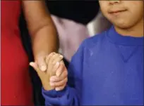  ??  ?? Darwin Micheal Mejia, right, holds hands with his mother, Beata Mariana de Jesus Mejia-Mejia, during a news conference following their reunion at Baltimore-Washington Internatio­nal Thurgood Marshall Airport on Friday in Linthicum, Md.