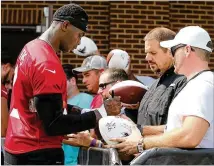  ?? CURTIS COMPTON / CCOMPTON@AJC.COM ?? Wide receiver Julio Jones signs autographs during the first day of Falcons training camp Thursday in Flowery Branch. He’s entering his seventh NFL season.