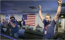  ?? BILL INGALLS — NASA VIA AP ?? Members of NASA’s Perseveran­ce rover team react in mission control after receiving confirmati­on the spacecraft successful­ly touched down on Mars Feb. 18, at NASA’s Jet Propulsion Laboratory in Pasadena, Ca.