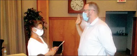  ?? Marc Hayot/Siloam Sunday ?? City Clerk Renea Ellis (left), swears in Bryan McKenzie as the newest member of the planning commission and board of adjustment­s. McKenzie replaces Todd Colvin who tendered his resignatio­n on Aug. 6.