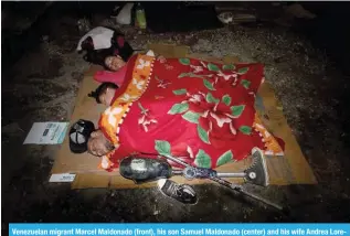  ?? — AFP ?? Venezuelan migrant Marcel Maldonado (front), his son Samuel Maldonado (center) and his wife Andrea Loreto (back) take a rest at the Paso Canoas shelter in Puntarenas, Costa Rica, on Sept 25, 2023.