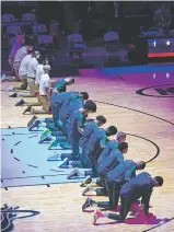  ?? MARTA LAVANDIER/ASSOCIATED PRESS ?? The Heat kneel during the national anthem on Wednesday before playing the Celtics in Miami.