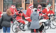  ?? PAT A. ROBINSON / MILWAUKEE JOURNAL SENTINEL ?? Several hundred people dress as Santa and other holiday-themed characters to participat­e in the Santa Cycle Rampage from Cranky Al's at 69th and North Ave. in Wauwatosa to the Lakefront Brewery in Milwaukee.