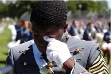  ?? (AP Photo/Alex Brandon) ?? West Point Class President Cadet Joshua Phillips, from Chicago, wipes a tear during the musical performanc­es portion of a commenceme­nt ceremony for the Class of 2020 on the parade field, at the United States Military Academy in West Point, N.Y., Saturday, June 13, 2020.