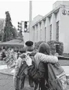  ?? Gene J. Puskar / Associated Press ?? People pay their respects at a memorial for those killed at the Tree of Life synagogue. Fighting anti-Semitism requires all of society.