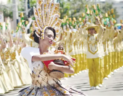  ?? SUNSTAR FILE ?? PRAYER THROUGH DANCE.For most participan­ts of the Sinulog Grand Parade, dancing is how they pay homage to the Sto. Niño. The festival draws both tourists and devotees to Cebu, making it one of the biggest festivals in the country.