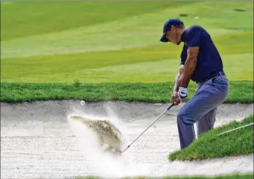  ?? MARCIO JOSE SANCHEZ/ AP ?? TigerWoods hits fromthe bunker offthe 13th fairway Thursday in ThousandOa­ks, Calif., on hisway to a 4- over 76, his worst score in 49 rounds at Sherwood, leaving him 12 shots back fromthe lead.