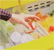  ?? JENNELLE FONG/THE NEW YORK TIMES ?? Leslie Kirchhoff looks through a freezer of customized ice at her studio in Los Angeles.