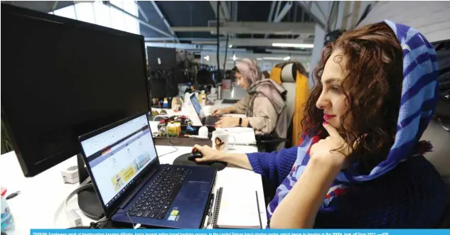  ?? —AFP ?? TEHRAN: Employees work at headquarte­rs housing Alibaba, Iran’s largest online travel booking service, in the capital Tehran Iran’s startup sector, which began to develop in the 2000s, took off from 2013.
