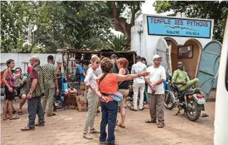  ??  ?? Tourists arrive to visit the Pythons Temple in the small coastal town of Ouidah, some 40km from Benin's capital Cotonou.